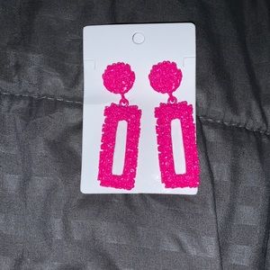 Pink earrings.
